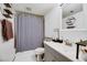 Neat bathroom featuring sink and shower with a stylish gray striped curtain at 3473 Monte Carlo Dr, Las Vegas, NV 89121