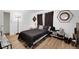 Cozy bedroom with modern decor, wood-look floors, contemporary lighting, and a comfortable queen-size bed at 3473 Monte Carlo Dr, Las Vegas, NV 89121
