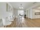 Bright dining area features modern decor, white table and chairs, and wood-look laminate flooring at 3473 Monte Carlo Dr, Las Vegas, NV 89121