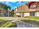 Inviting townhouse featuring a well-manicured lawn, mature trees, and covered entryway at 3473 Monte Carlo Dr, Las Vegas, NV 89121
