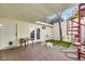 Inviting outdoor patio featuring a spiral staircase, seating, grill, and tiled flooring with artificial turf at 3473 Monte Carlo Dr, Las Vegas, NV 89121