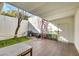 Outdoor patio with spiral staircase, grill, green turf, outdoor seating, and tiled flooring at 3473 Monte Carlo Dr, Las Vegas, NV 89121
