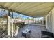 Spacious covered patio area with stone floors, decorative ivy, wrought iron, and an outdoor seating arrangement at 3473 Monte Carlo Dr, Las Vegas, NV 89121