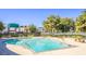 Inviting community pool surrounded by lush landscaping and seating areas on a sunny day at 3473 Monte Carlo Dr, Las Vegas, NV 89121
