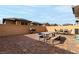 Spacious backyard with a dining table, gravel landscaping, and brick-paved patio at 365 Andy Wheeler Dr, Henderson, NV 89011