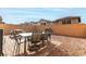 Outdoor patio features an outdoor dining set, built-in grill, and low-maintenance gravel at 365 Andy Wheeler Dr, Henderson, NV 89011