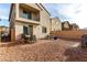 Backyard features a dining table and gravel landscaping, perfect for outdoor entertaining at 365 Andy Wheeler Dr, Henderson, NV 89011