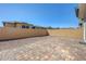 Spacious backyard with brick perimeter walls and a large brick paver patio at 365 Andy Wheeler Dr, Henderson, NV 89011