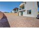 Property with a paved patio, gravel, brick walls, a sliding glass door, and a second story balcony at 365 Andy Wheeler Dr, Henderson, NV 89011