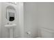 A half bathroom with a modern pedestal sink and toilet at 365 Andy Wheeler Dr, Henderson, NV 89011