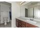 Bright bathroom features a single vanity, large mirror, and shower-tub combination at 365 Andy Wheeler Dr, Henderson, NV 89011