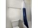 The bathroom features a tub with a blue shower curtain, toilet, and towel rack at 365 Andy Wheeler Dr, Henderson, NV 89011