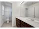 Bathroom featuring a granite countertop and wooden cabinetry, as well as a shower/tub combo at 365 Andy Wheeler Dr, Henderson, NV 89011