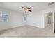 Carpeted bedroom with ceiling fan and two windows letting in natural light at 365 Andy Wheeler Dr, Henderson, NV 89011