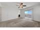 Bedroom featuring neutral carpet, ceiling fan, and access to an outdoor balcony at 365 Andy Wheeler Dr, Henderson, NV 89011