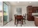 A dining area featuring a sliding glass door leading to the patio and dark wood furniture at 365 Andy Wheeler Dr, Henderson, NV 89011