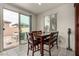 A dining area featuring a sliding glass door leading to the patio and dark wood furniture, and a mounted vaccuum cleaner at 365 Andy Wheeler Dr, Henderson, NV 89011
