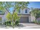 Inviting two-story home featuring a paved driveway and tidy front yard at 365 Andy Wheeler Dr, Henderson, NV 89011