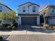 Charming two-story home with a well-maintained front yard and a two-car garage at 365 Andy Wheeler Dr, Henderson, NV 89011