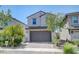 Attractive home showcasing a 2-car garage and well-maintained landscaping at 365 Andy Wheeler Dr, Henderson, NV 89011