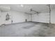 An empty two car garage with concrete floor and white walls at 365 Andy Wheeler Dr, Henderson, NV 89011