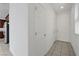 Clean hallway with tiled flooring, white walls, and natural light from a window at 365 Andy Wheeler Dr, Henderson, NV 89011
