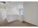Carpeted upstairs landing area with access to bedrooms and a small window at 365 Andy Wheeler Dr, Henderson, NV 89011