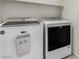 Laundry room featuring a white Maytag washer and dryer with a convenient shelf above at 365 Andy Wheeler Dr, Henderson, NV 89011