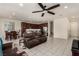 Spacious living area with tile flooring, ceiling fan, and an open layout to the kitchen and dining area at 365 Andy Wheeler Dr, Henderson, NV 89011