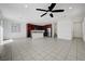 Open-concept living room and kitchen with tile flooring and a modern ceiling fan at 365 Andy Wheeler Dr, Henderson, NV 89011