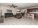Open-concept living room features tile floors, ceiling fan, and a spacious seating area adjacent to the kitchen at 365 Andy Wheeler Dr, Henderson, NV 89011
