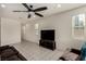 Spacious living room featuring modern ceiling fan, large windows, and tiled floors at 365 Andy Wheeler Dr, Henderson, NV 89011
