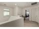 Upstairs loft area offers flexible space with carpet, neutral walls, and a glimpse into the adjacent bedroom at 365 Andy Wheeler Dr, Henderson, NV 89011