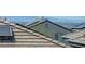 A rooftop featuring a tile roof with solar panels and a view of the Las Vegas skyline at 365 Andy Wheeler Dr, Henderson, NV 89011