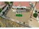Aerial view of a spacious backyard with gravel landscaping, covered patio, and a charming fire pit area, great for entertaining at 412 Lost Trail Dr, Henderson, NV 89014
