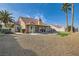 Spacious backyard featuring a well-maintained patio, gravel landscaping, and mature palm trees, perfect for outdoor relaxation at 412 Lost Trail Dr, Henderson, NV 89014