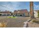 Spacious backyard with a fire pit, gravel landscaping, and a covered patio, perfect for entertaining and enjoying outdoor living at 412 Lost Trail Dr, Henderson, NV 89014