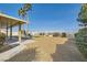 Large backyard with a covered patio, gravel, view fence, and desert landscaping at 412 Lost Trail Dr, Henderson, NV 89014