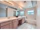 Double sink bathroom with decorative tile and a large mirror at 412 Lost Trail Dr, Henderson, NV 89014