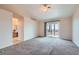 Spacious bedroom with plush carpet, ceiling fan, and sliding glass door to outdoor patio at 412 Lost Trail Dr, Henderson, NV 89014