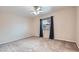 Neutral bedroom with carpet, ceiling fan, window with blue curtains and ample natural light, creating a serene and inviting space at 412 Lost Trail Dr, Henderson, NV 89014