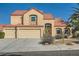 Charming two-story home with a red tile roof, three car garage, and desert landscaping at 412 Lost Trail Dr, Henderson, NV 89014