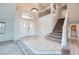 Inviting foyer with tiled floors, a staircase, and double doors leading to the interior at 412 Lost Trail Dr, Henderson, NV 89014