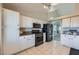 Well-lit kitchen featuring white cabinets, stainless steel appliances, and tile flooring at 412 Lost Trail Dr, Henderson, NV 89014