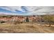 Cityscape view featuring a dry landscape with desert foliage, homes with red-tiled roofs, and a mountainous skyline backdrop at 412 Lost Trail Dr, Henderson, NV 89014