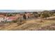 Cityscape view featuring a dry landscape with desert foliage, homes with red-tiled roofs, and a mountainous skyline backdrop at 412 Lost Trail Dr, Henderson, NV 89014