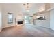Inviting living room with fireplace, chandelier, slider to patio, and seamless kitchen access at 412 Lost Trail Dr, Henderson, NV 89014
