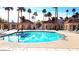 Sparkling community pool surrounded by lush landscaping, elegant pavilions, and comfortable lounge chairs at 412 Lost Trail Dr, Henderson, NV 89014