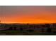 Backyard view of a colorful sunset over the city skyline at 412 Lost Trail Dr, Henderson, NV 89014