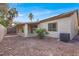 Backyard showcasing covered patio, desert landscaping, and a glimpse of palm trees at 4546 Cliff Breeze Dr, North Las Vegas, NV 89081